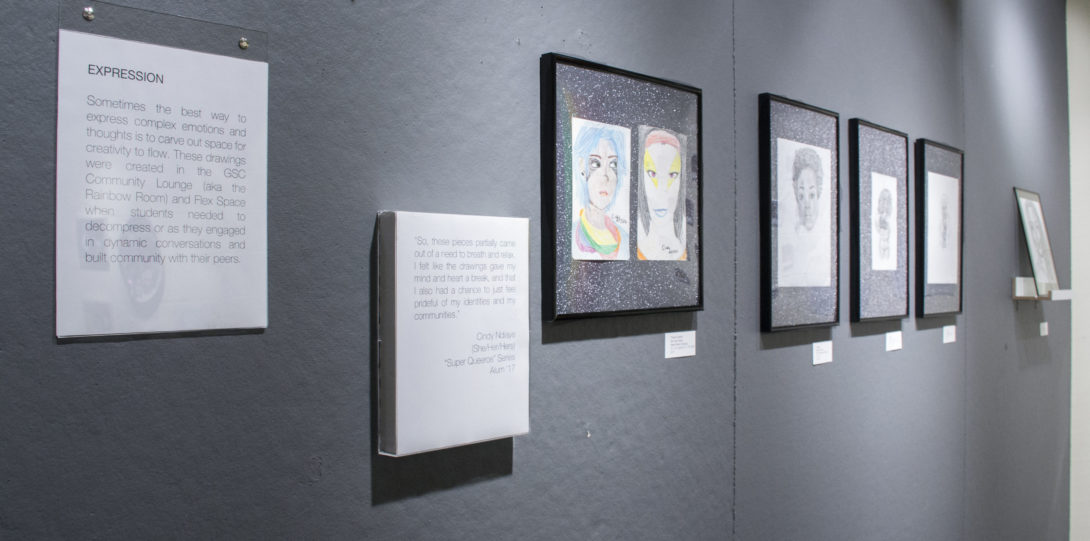 Photograph of multiple pieces (drawings) on a grey wall